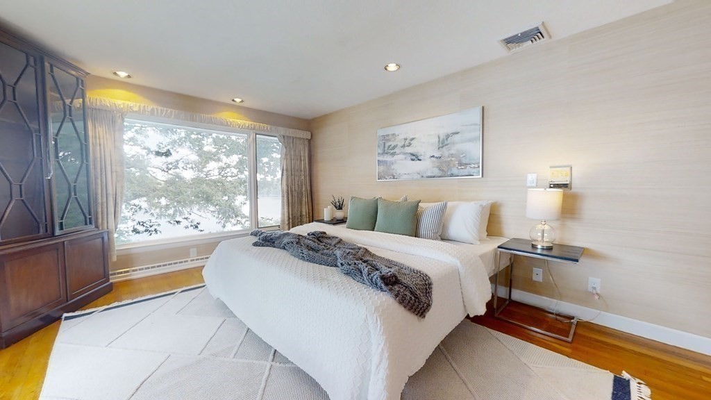 39 Beverly Road Arlington, MA 02474 - Photo 17 of 37 a spacious bedroom with a bed and a large window