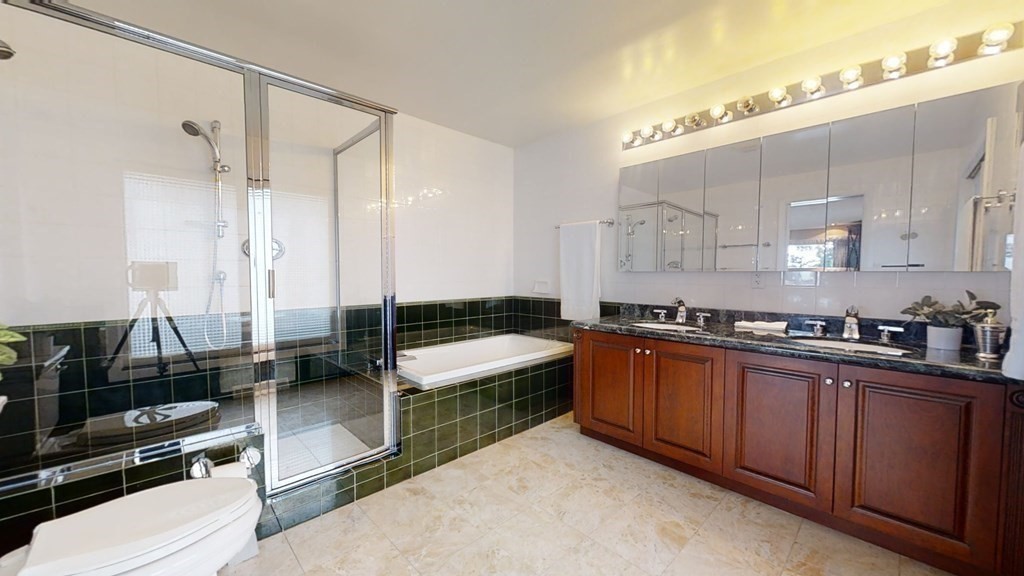 39 Beverly Road Arlington, MA 02474 - Photo 19 of 37 a large kitchen with kitchen island granite countertop a sink and white cabinets