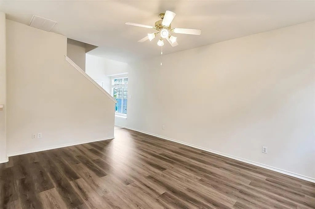 2 Peach Ridge Place The Woodlands, TX 77382 - Photo 13 of 29 a view of an empty room with wooden floor
