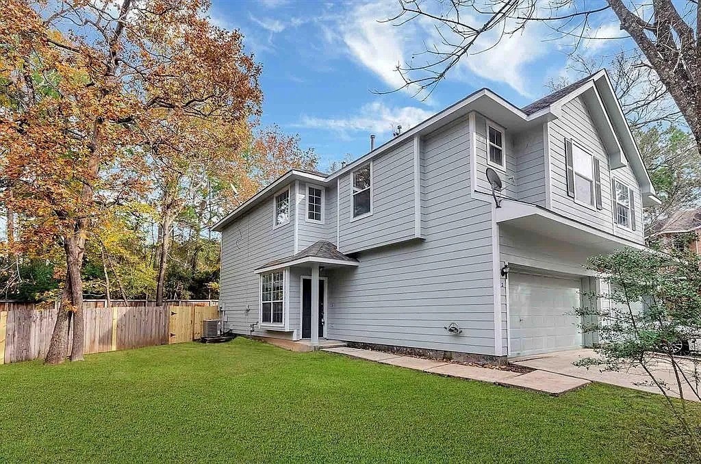 2 Peach Ridge Place The Woodlands, TX 77382 - Photo 2 of 29 a view of a house with a yard