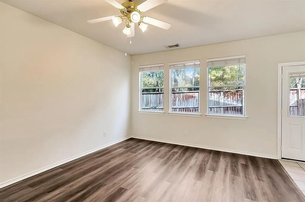 2 Peach Ridge Place The Woodlands, TX 77382 - Photo 21 of 29 a view of an empty room with wooden floor and a window