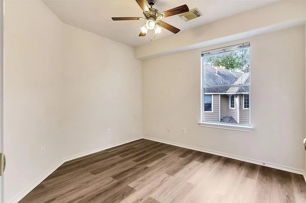 2 Peach Ridge Place The Woodlands, TX 77382 - Photo 22 of 29 a view of empty room with wooden floor and fan