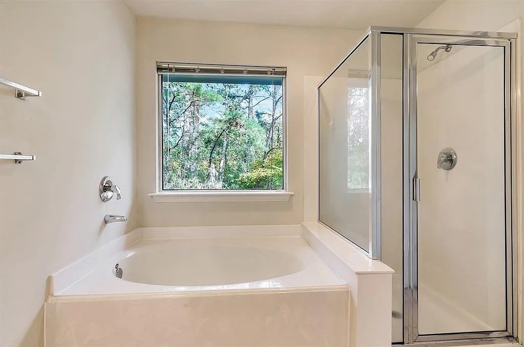 2 Peach Ridge Place The Woodlands, TX 77382 - Photo 24 of 29 a white bath tub sitting next to a window