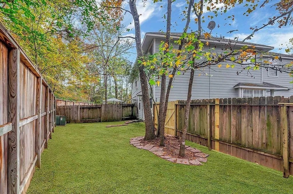 2 Peach Ridge Place The Woodlands, TX 77382 - Photo 26 of 29 a view of a backyard with potted plants and large tree
