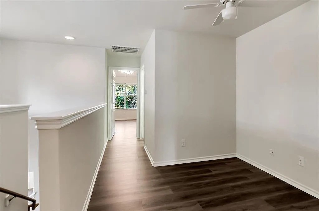 2 Peach Ridge Place The Woodlands, TX 77382 - Photo 27 of 29 wooden floor in an empty room with a window