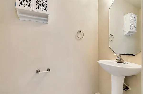 a bathroom with a sink and mirror