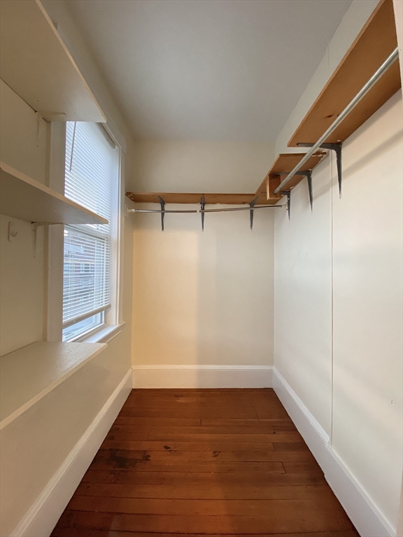 257 Beacon Street, Unit 3 Somerville, MA 02143 - Photo 12 of 15 a view of an empty room with wooden floor and a window