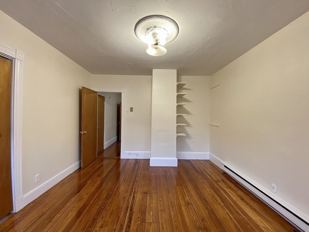 257 Beacon Street, Unit 3 Somerville, MA 02143 - Photo 6 of 15 a view of empty room with wooden floor