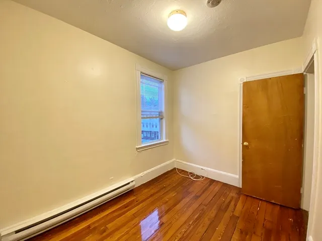 an empty room with wooden floor