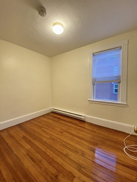 257 Beacon Street, Unit 3 Somerville, MA 02143 - Photo 10 of 15 a view of empty room with wooden floor