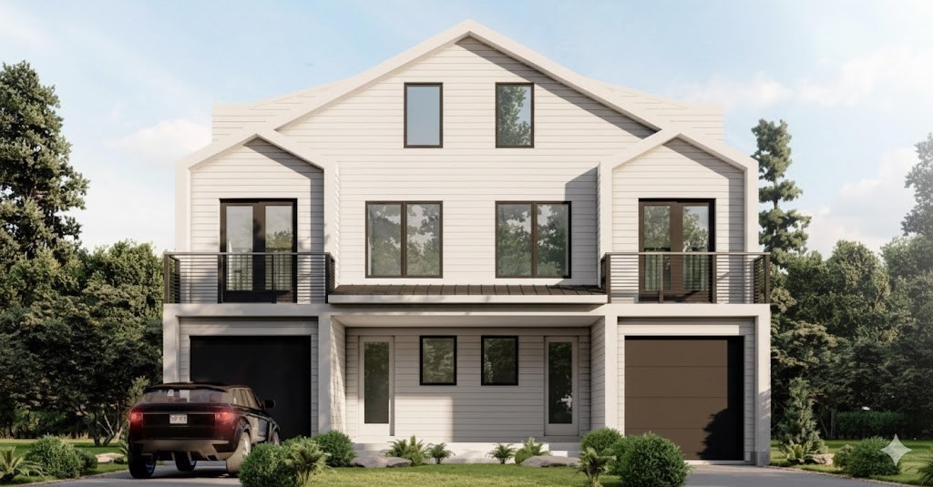 a view of a white house with large windows and a small yard