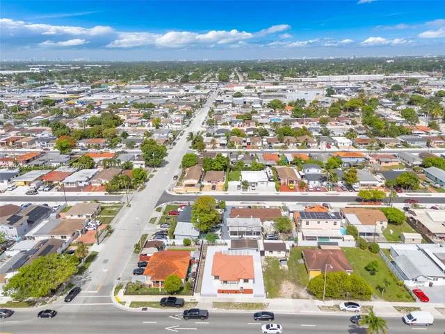 an aerial view of residential houses with outdoor space