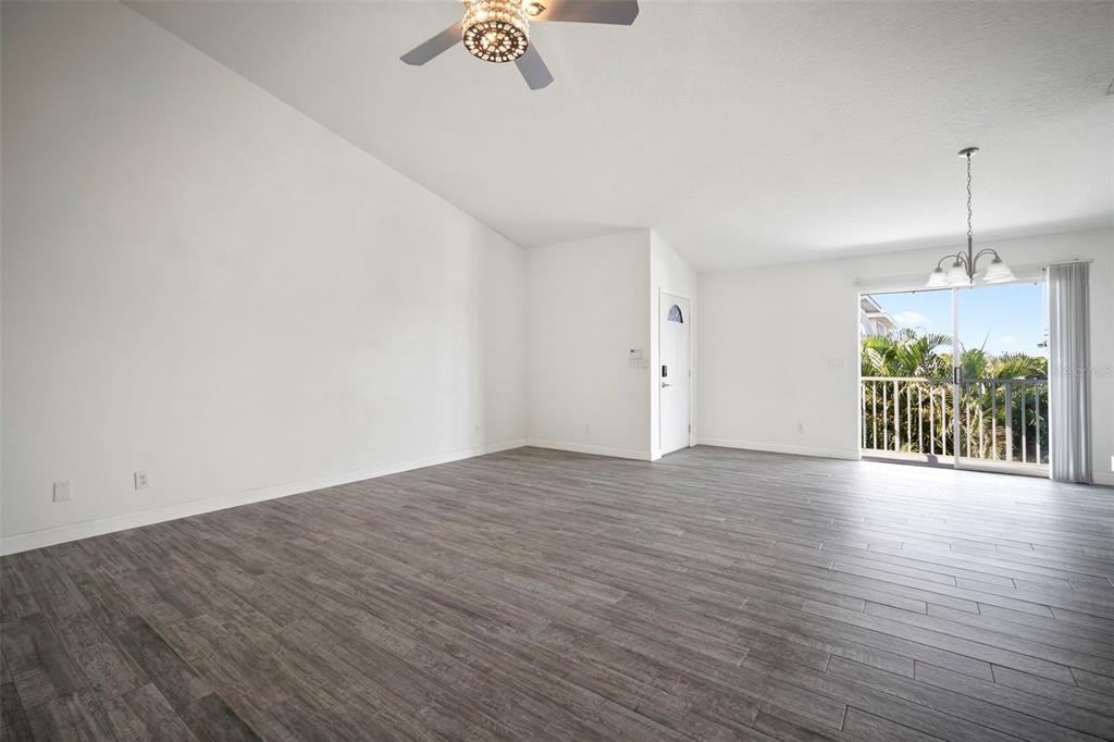 1013 Apollo Beach Boulevard, Unit 203 Apollo Beach, FL 33572 - Photo 19 of 26 an empty room with wooden floor and windows