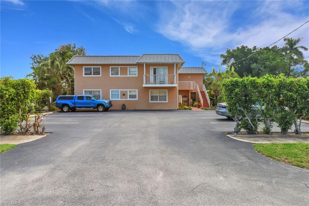 1195 Clam Court, Unit 202 Naples, FL 34102 - Photo 2 of 5 a view of a house with a yard and sitting area