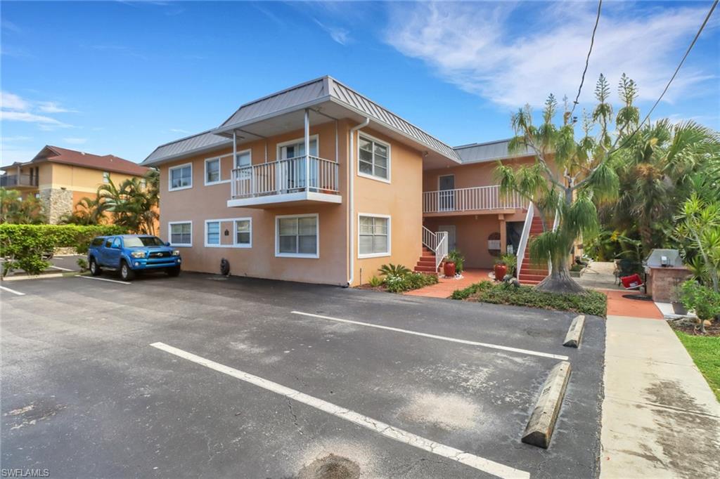 1195 Clam Court, Unit 202 Naples, FL 34102 - Photo 4 of 5 a front view of a house with a yard