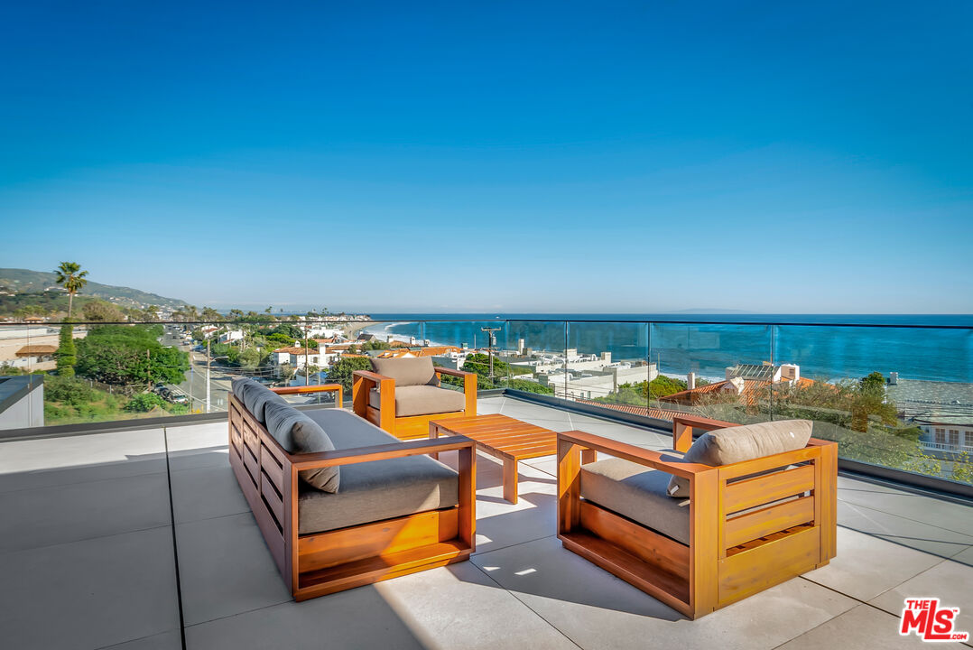 23917 Malibu Road Malibu, CA 90265 - Photo 3 of 62 a view of a chairs and table in a terrace
