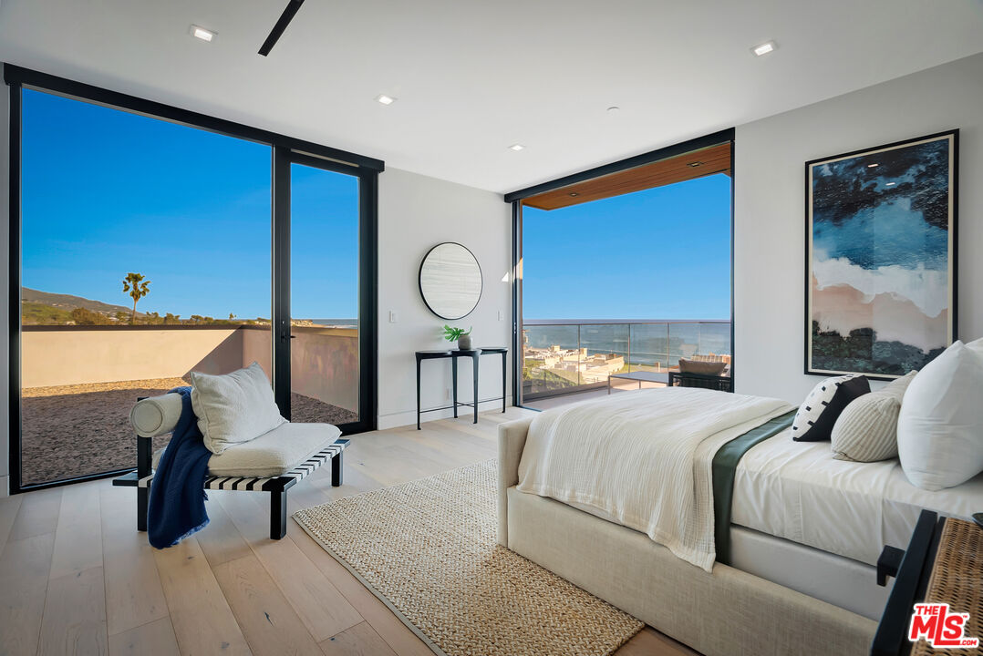 23917 Malibu Road Malibu, CA 90265 - Photo 39 of 62 a bedroom with furniture and a large window