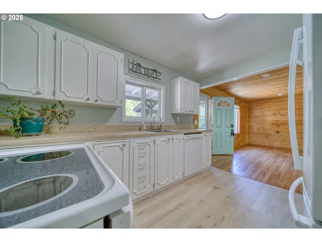 a kitchen with sink and cabinets