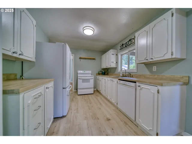 a kitchen with cabinets and stainless steel appliances