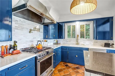 a kitchen with stainless steel appliances a refrigerator sink and cabinets