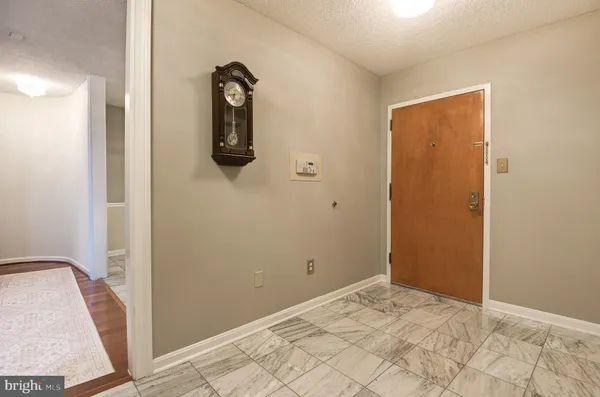 a view of front door with a mirror