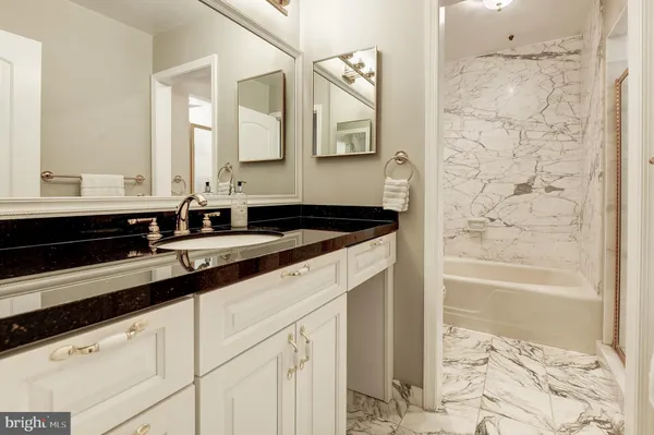 a bathroom with a bathtub and a sink