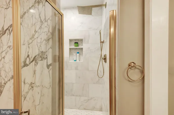 a bathroom with a granite countertop shower and a sink