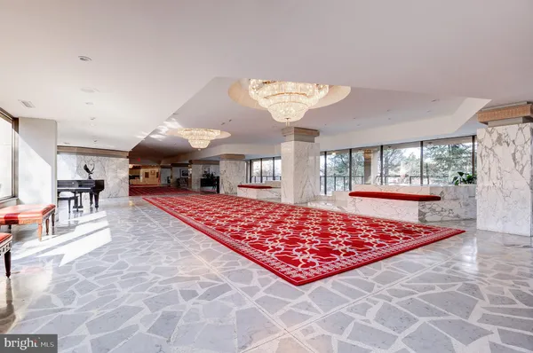 a living room with a rug and a table