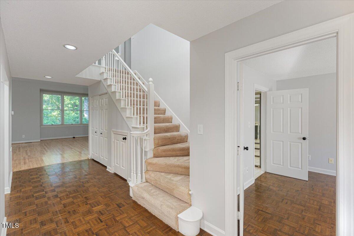 411 Brampton Close Pittsboro, NC 27312 - Photo 22 of 71 a view of a hallway view with wooden floor and staircase