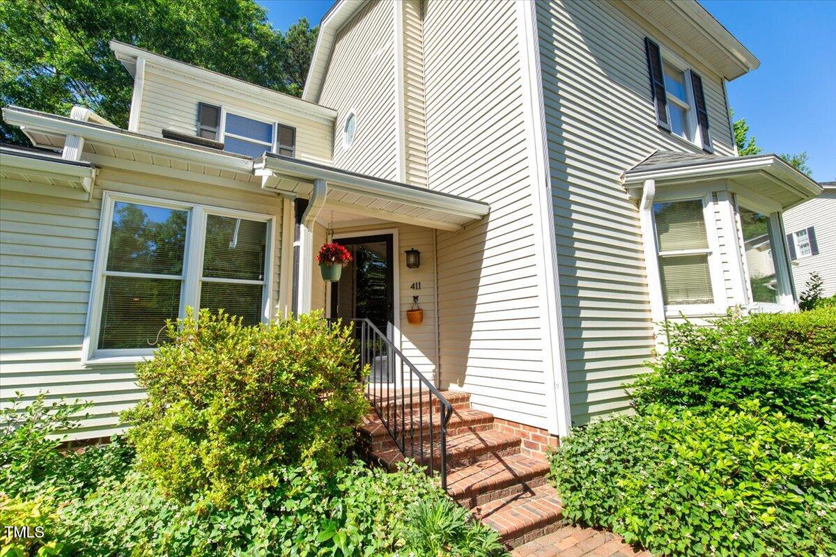 411 Brampton Close Pittsboro, NC 27312 - Photo 3 of 71 a front view of a house with garden