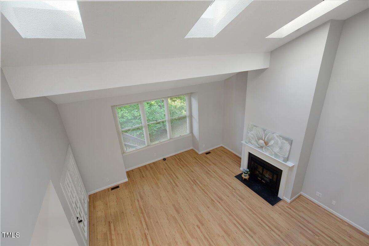 411 Brampton Close Pittsboro, NC 27312 - Photo 40 of 71 an empty room with wooden floor and a window
