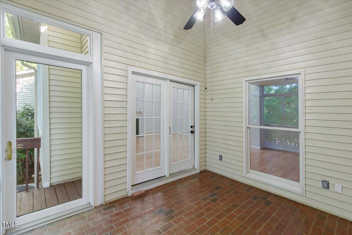 411 Brampton Close Pittsboro, NC 27312 - Photo 44 of 71 an empty room with wooden floor chandelier fan and windows