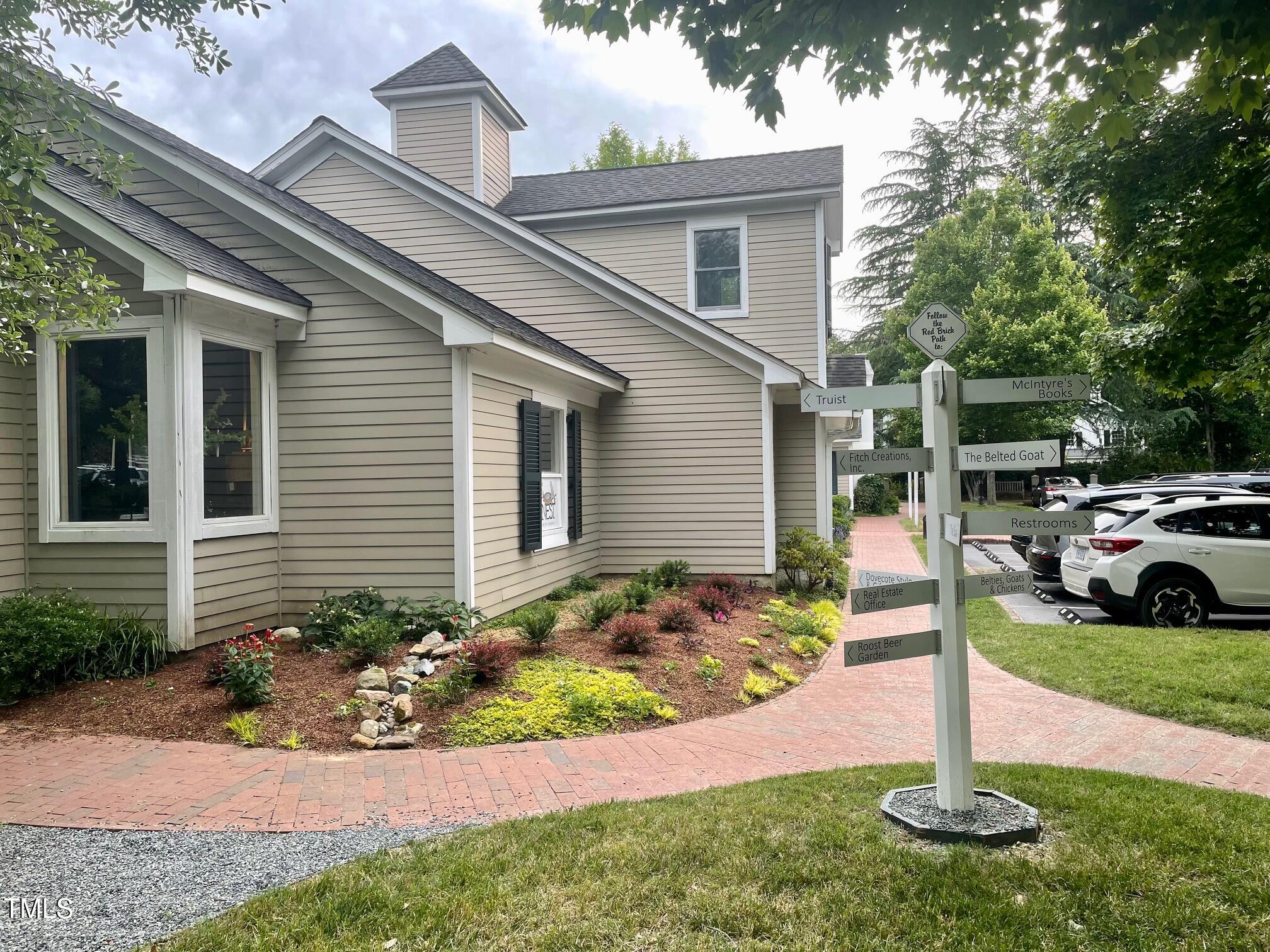 411 Brampton Close Pittsboro, NC 27312 - Photo 56 of 71 a front view of a house with a yard and seating space