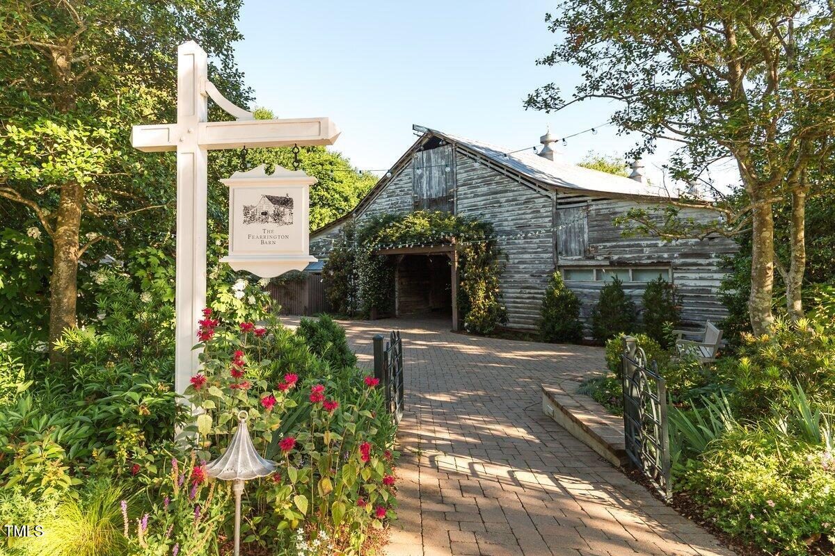 411 Brampton Close Pittsboro, NC 27312 - Photo 60 of 71 a front view of a house with a yard and garage