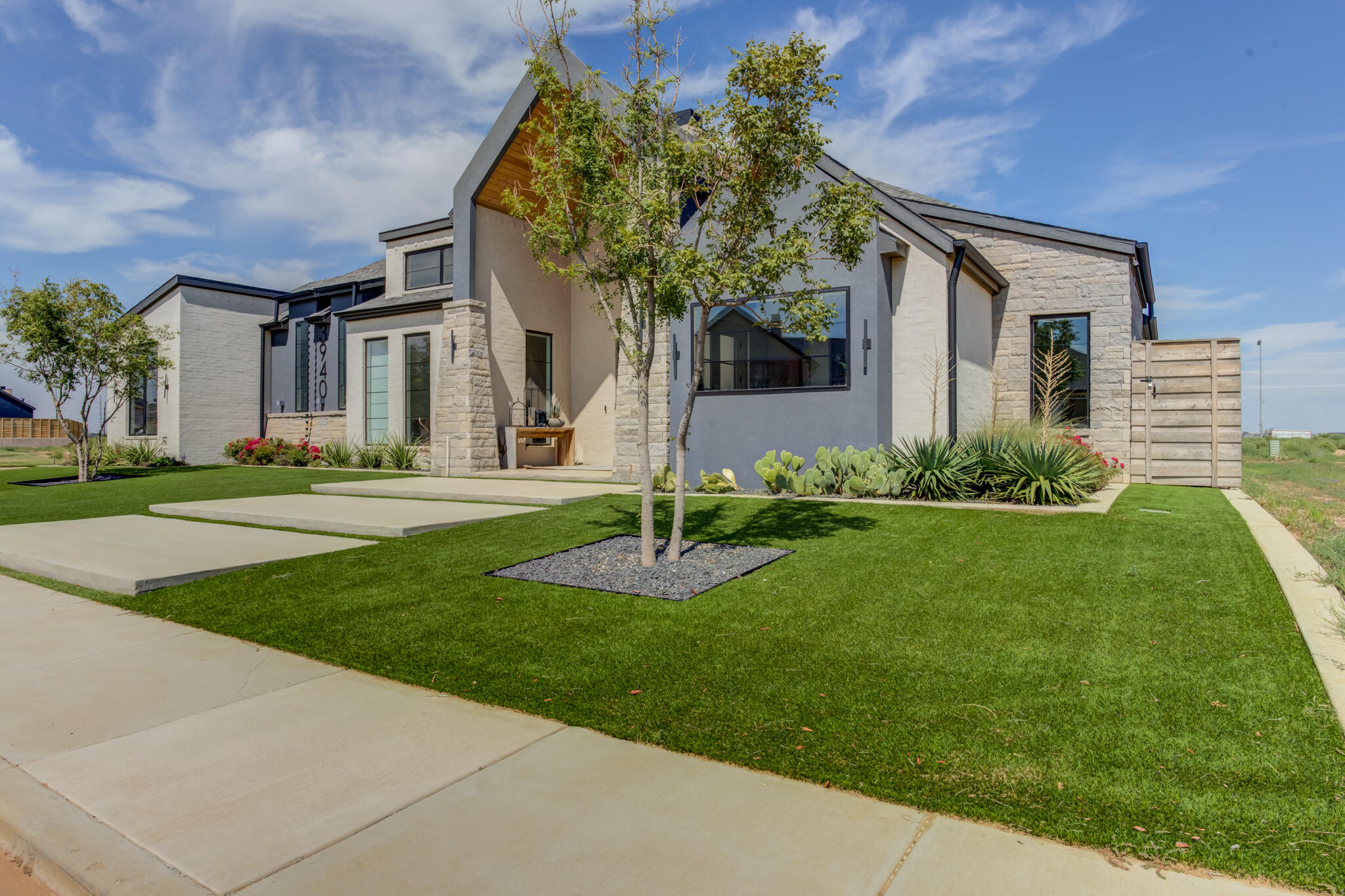 3940 148th Street Lubbock, TX 79423 - Photo 2 of 92 a front view of a house with a garden
