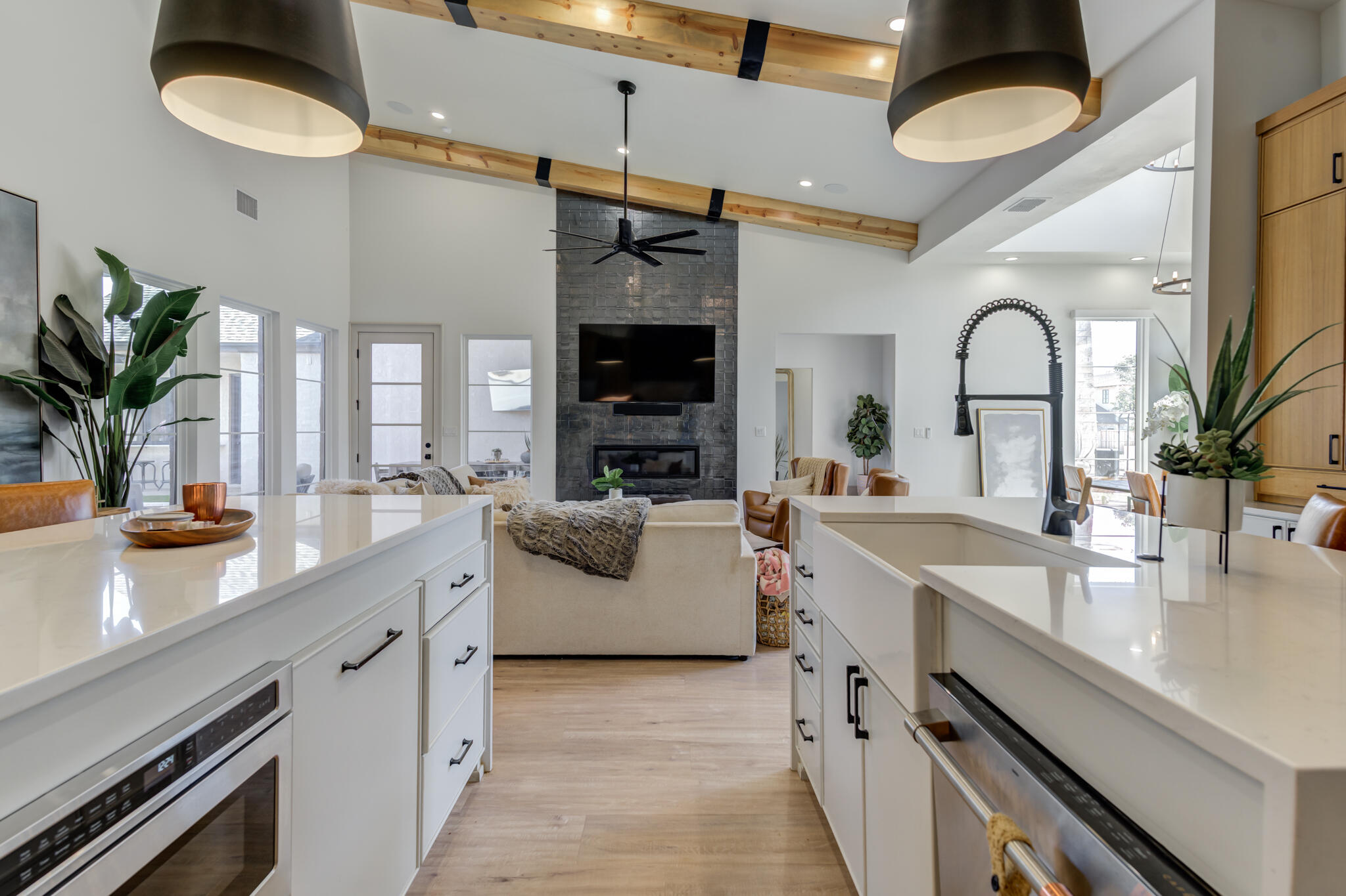 3940 148th Street Lubbock, TX 79423 - Photo 33 of 92 a kitchen with a sink dishwasher a stove and a dining table with wooden floor