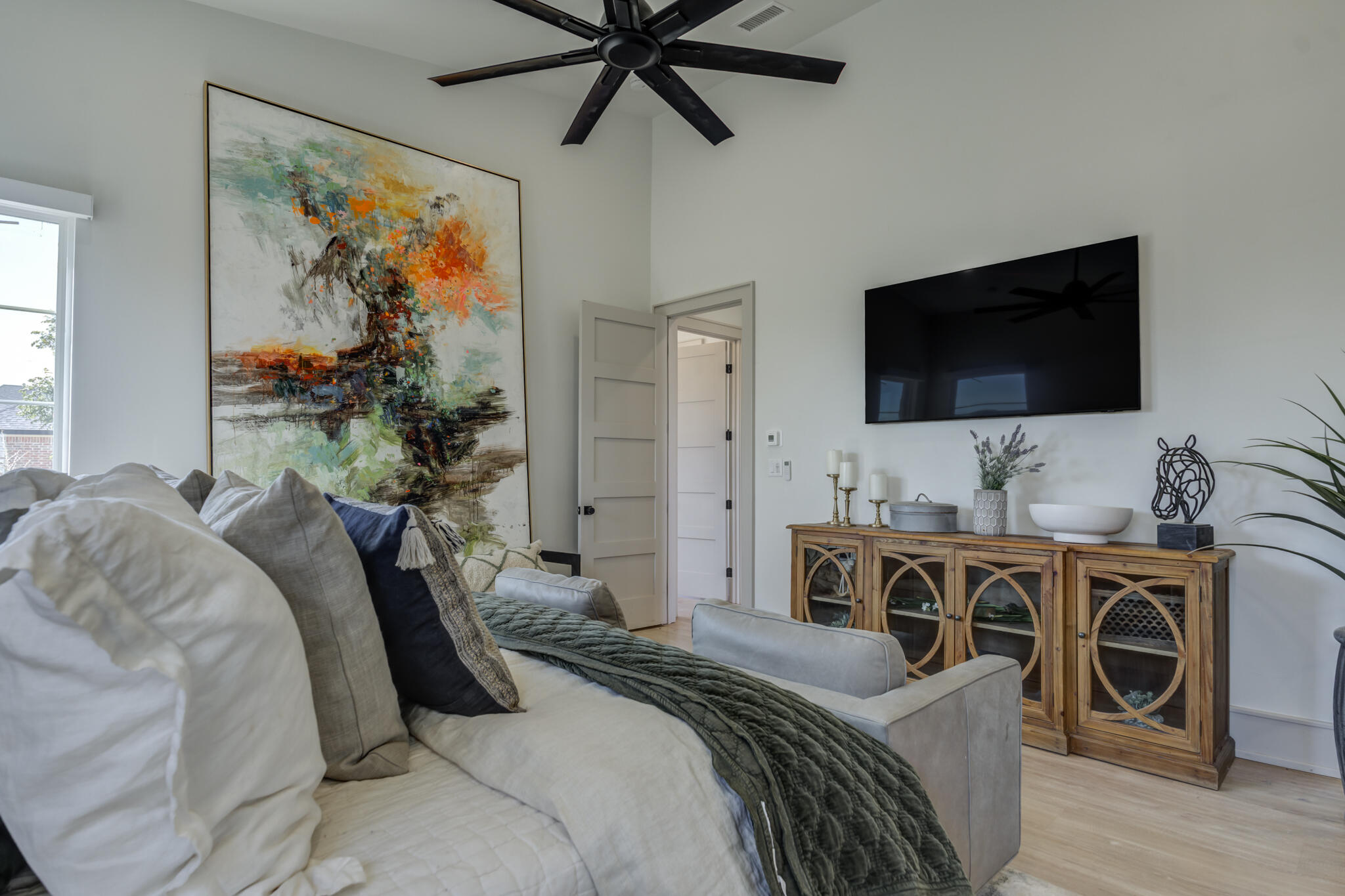 3940 148th Street Lubbock, TX 79423 - Photo 44 of 92 a bedroom with a bed and a flat screen tv