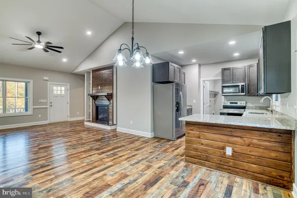 a view of kitchen with sink microwave and refrigerator