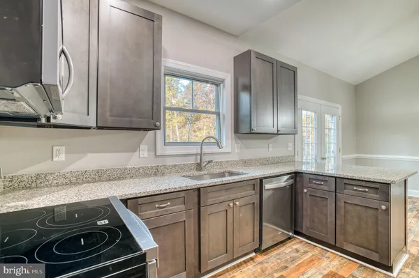 a kitchen with a sink stove and cabinets