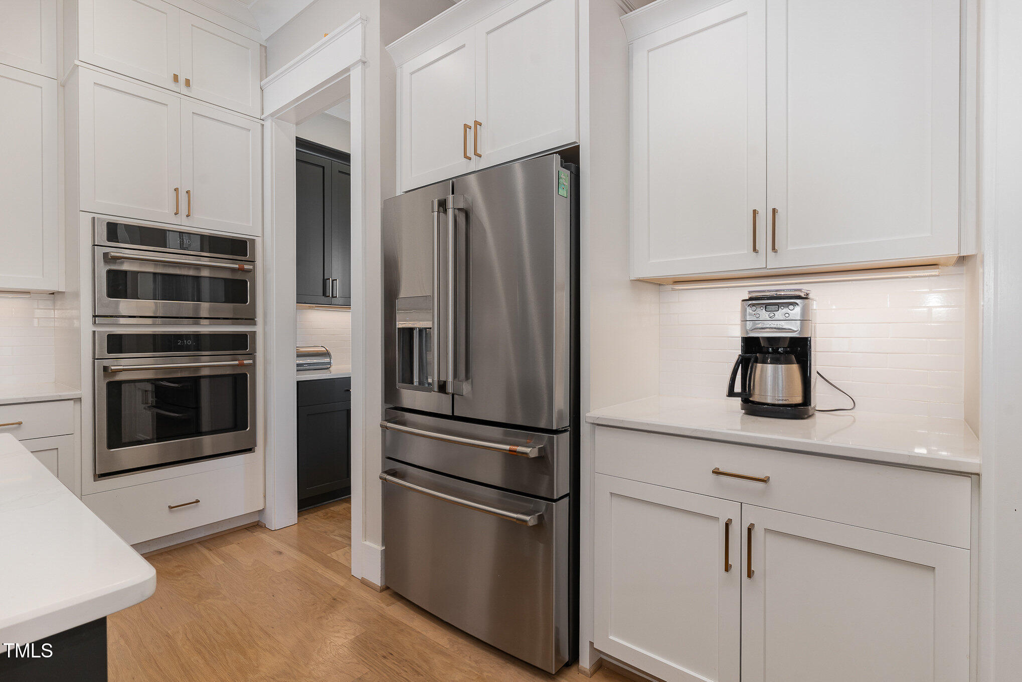 403 Stonecrest Way Pittsboro, NC 27312 - Photo 16 of 65 a metallic refrigerator freezer and a stove sitting inside of a kitchen