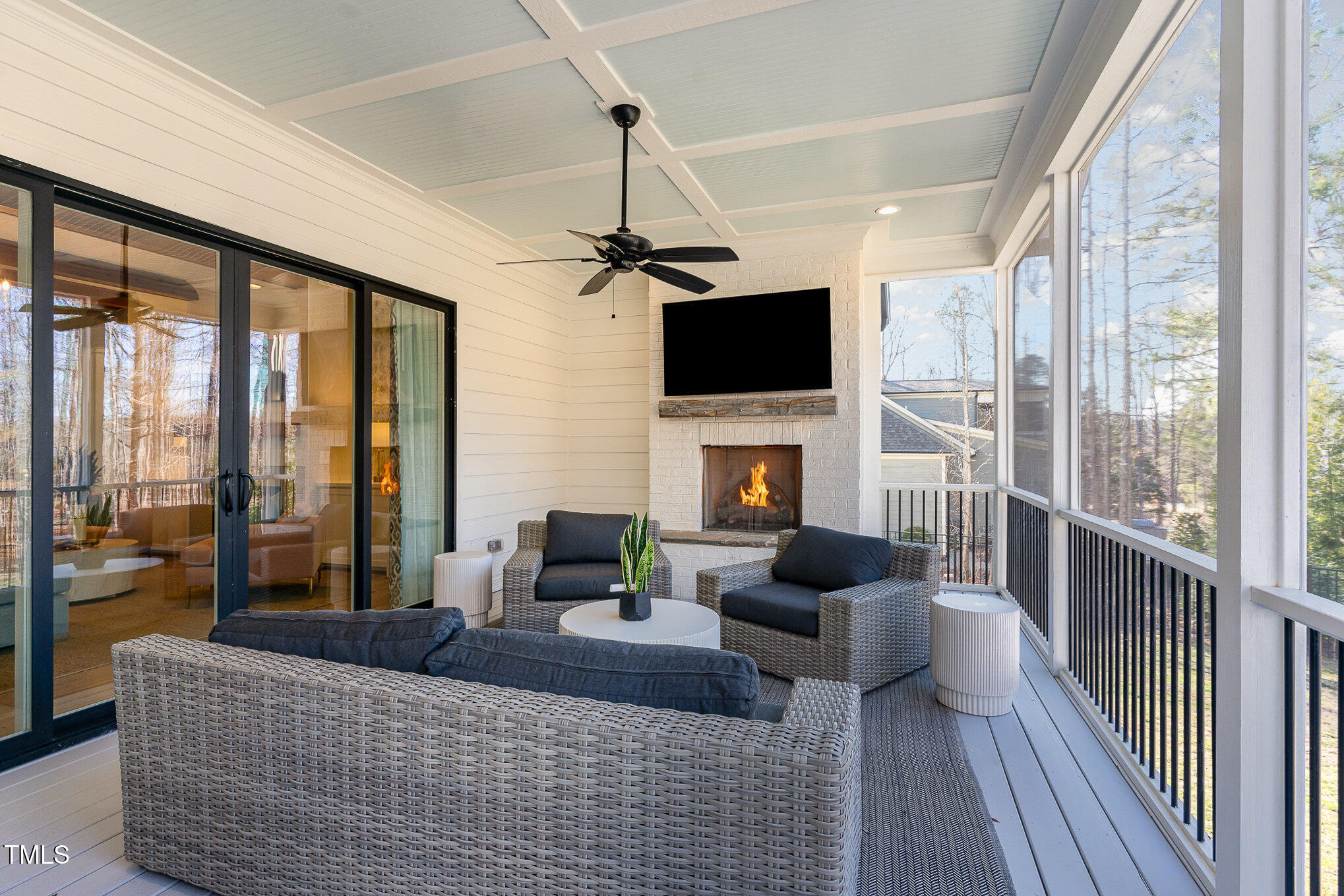 403 Stonecrest Way Pittsboro, NC 27312 - Photo 37 of 65 a living room with furniture a fireplace and a flat screen tv