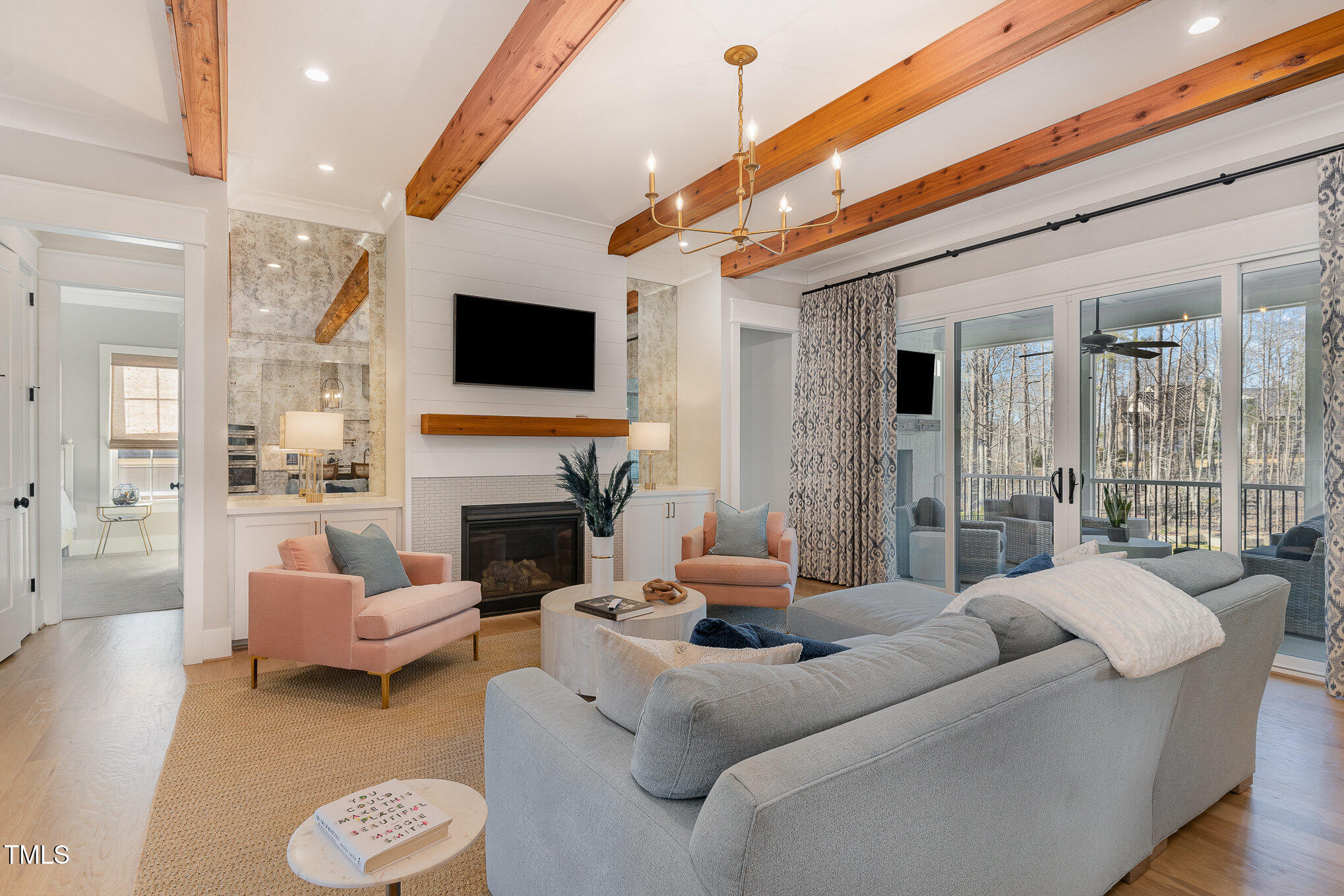 403 Stonecrest Way Pittsboro, NC 27312 - Photo 5 of 65 a living room with furniture a fireplace and a flat screen tv