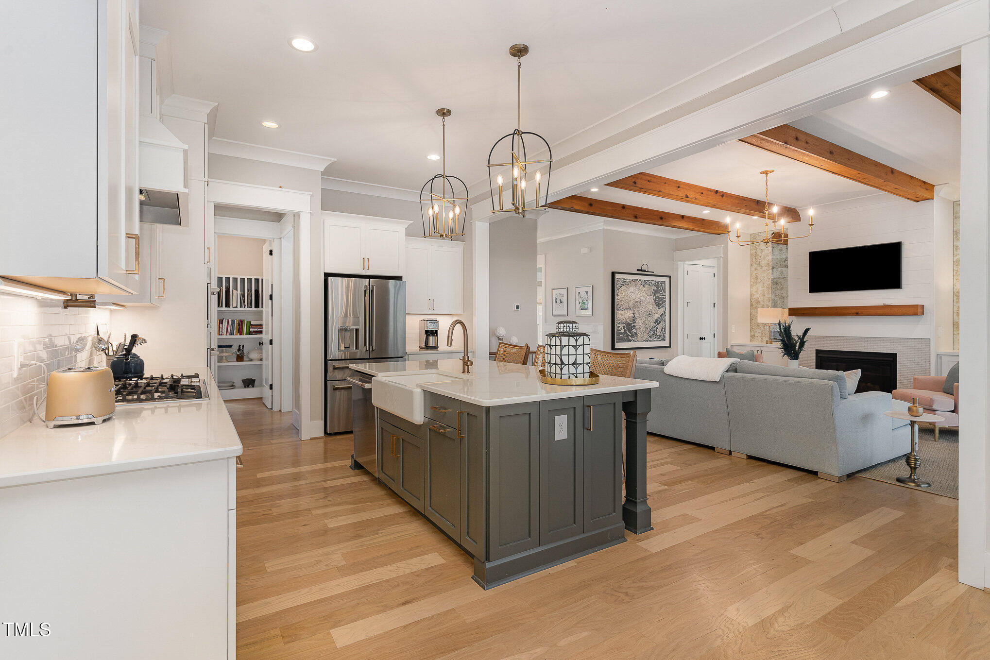 403 Stonecrest Way Pittsboro, NC 27312 - Photo 10 of 65 a large kitchen with stainless steel appliances granite countertop a large stove a sink dishwasher and a fireplace with wooden floor