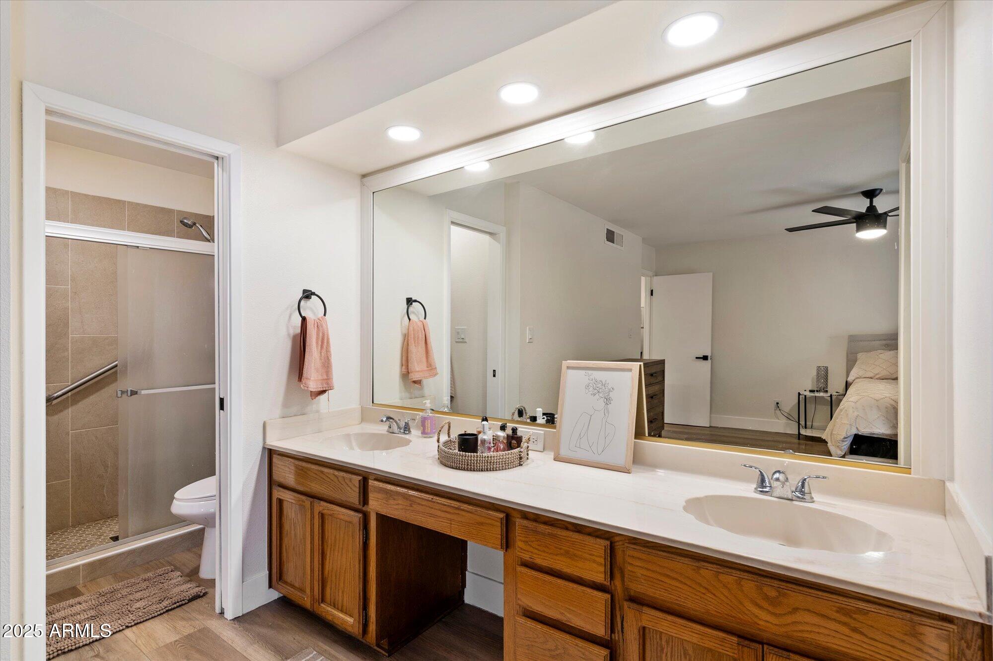 3415 North 36th Street, Unit 4 Phoenix, AZ 85018 - Photo 11 of 15 a bathroom with a double vanity sink mirror double and toilet