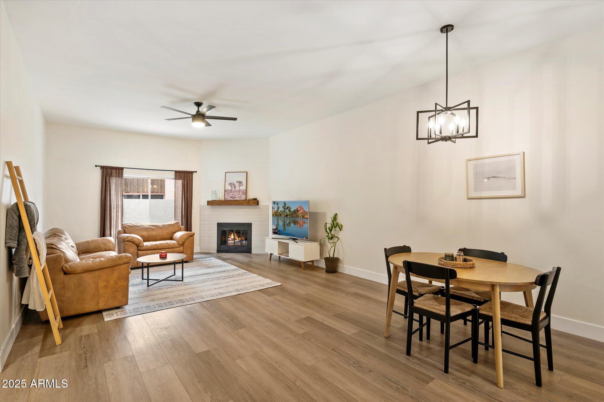3415 North 36th Street, Unit 4 Phoenix, AZ 85018 - Photo 3 of 15 a living room with furniture a fireplace and wooden floor