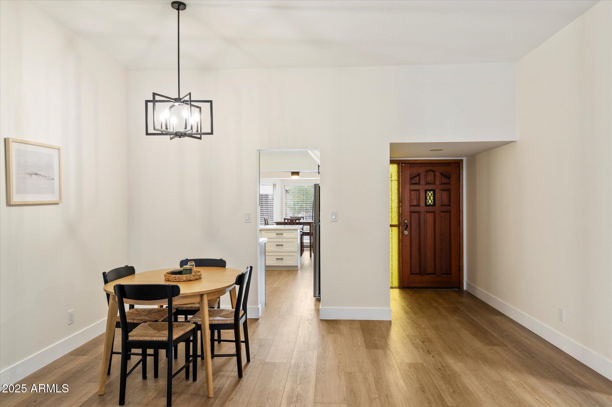 3415 North 36th Street, Unit 4 Phoenix, AZ 85018 - Photo 4 of 15 a view of a dining room with furniture and wooden floor