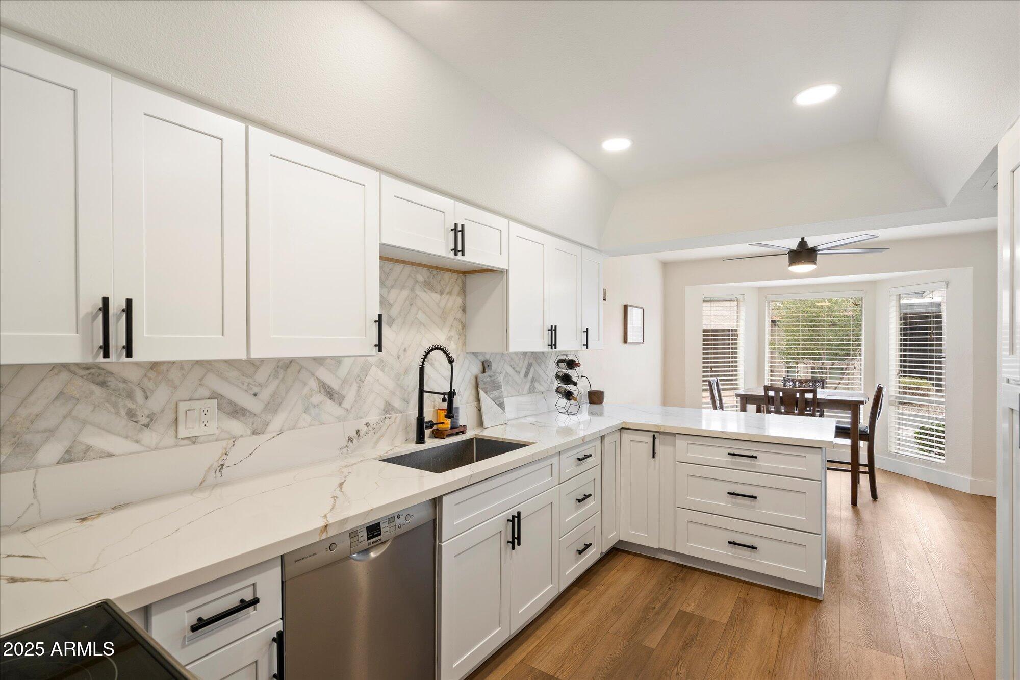 3415 North 36th Street, Unit 4 Phoenix, AZ 85018 - Photo 5 of 15 a kitchen with a sink stove and cabinets