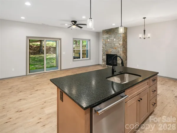 a kitchen with a sink a center island and windows