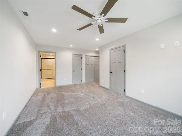 a view of an empty room with a ceiling fan