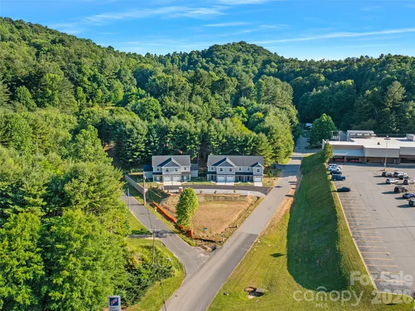 a view of a swimming pool with a patio and a yard